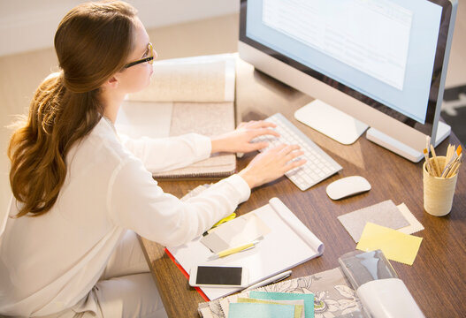Interior designer working at computer in home office