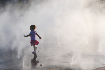 A child runs through steam attraction