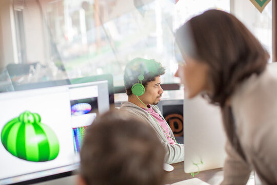 Creative graphic designers working at computers in office