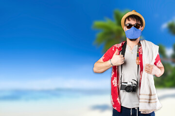 Male tourist on the beach with his face mask