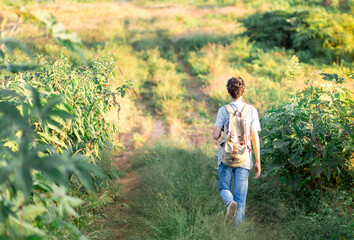 Backpacker walking and following the road