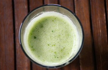Green drink on the wooden table.