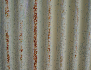 Old weathered corrugated sheet /panel with peeled paint. Background texture of rusty painted corrugated iron cladding