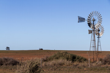 A handmade old windmill in a rural field, Australia