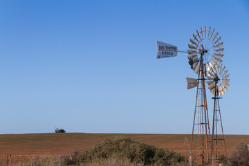 A handmade old windmill in a rural field, Australia