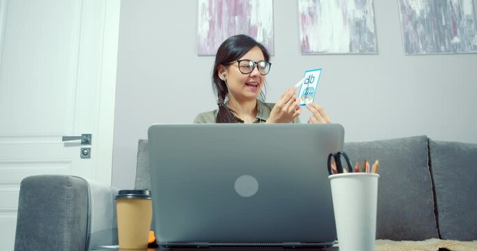 Young woman teacher showing picture with the alphabet, learning letters, studying with a child or kids online using a laptop at home. Preschool Online Education Concept