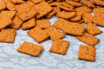 Salted crackers with spices on a light tablecloth. Close-up.