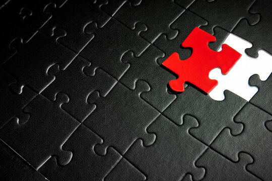 The puzzle is black with one red element.