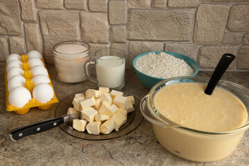 Ingredients for the dough for homemade waffles laid out on the table. Eggs, sugar, flour,...