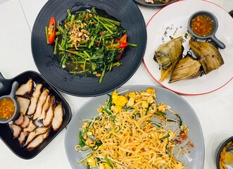 Tradition Northern Thai food on a white wooden table, top view. 