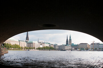Fototapeta premium The skyline of Hamburg from under the bridge from the ferry. The ferry is one of the best way to travel around the city.