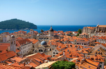 Fototapeta na wymiar red roofs of Dubrovnik old town Croatia with a clear blue sky and Adriatic sea in the background