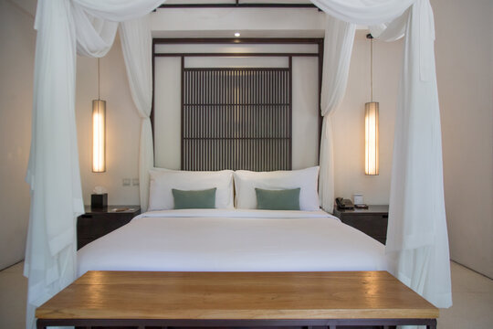 Simple contemporary bedroom with king size bed and mosquito net