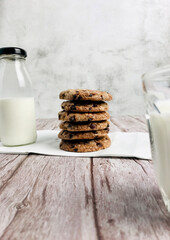 milk and cookies on wooden table