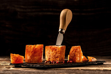 spicy cheese with pepper, tomato sauce on a wooden table. eco product. space for text