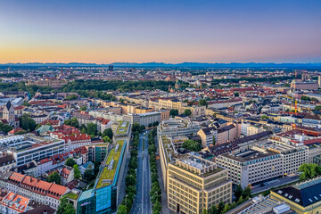 Fototapeta na wymiar Aerial view over Munich with offices and houses and the alp mountains in the background.