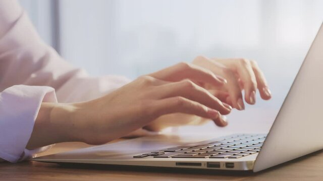 Freelance work. Home office. Business woman hands typing on modern laptop.