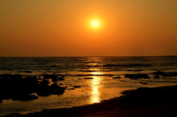 Beautiful sunset over the sea with a blurred view at St. Martins Island. The sunlight reflecting on the seawater. Blur Background with golden and reddish sunset abstract. Famous place for Tourism.