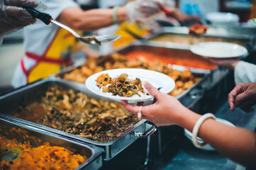 Homeless and needy people receive help, receive food from volunteers : concept of food donation