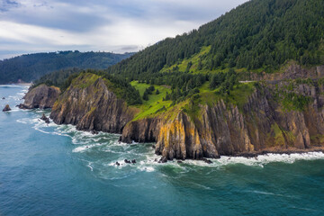 Fototapeta na wymiar High cliffs and rock formations on the ocean coast