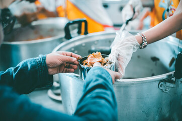 The hands of the poor receive food from the hands of the philanthropist : concept of giving