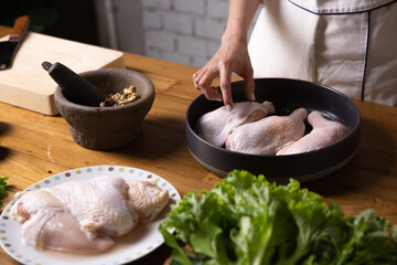 The chef cooks marinated chicken in his kitchen.