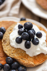 Oatmeal pancakes topped with yogurt and blueberries