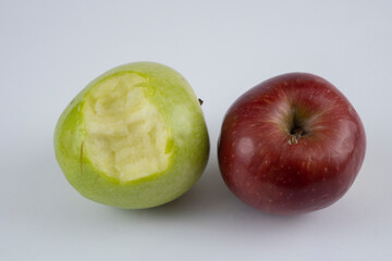 Bitten green and red apple on a white background