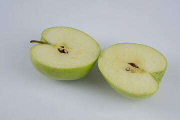 Red and green apple, half apple, bitten apple on a white background, seeds