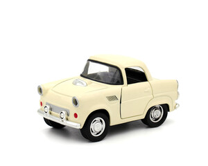 Miniature cream color toy car on white background