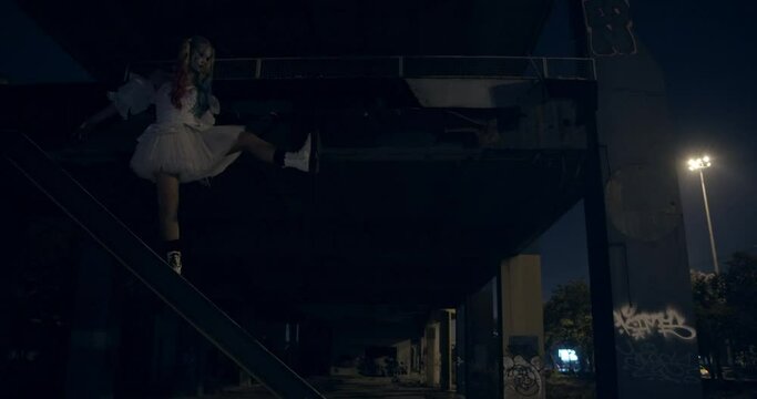 Woman in Halloween Costume by the Inclined Metal Railings Under the Bridge