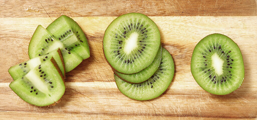 sliced kiwi fruit on wooden table, close view
