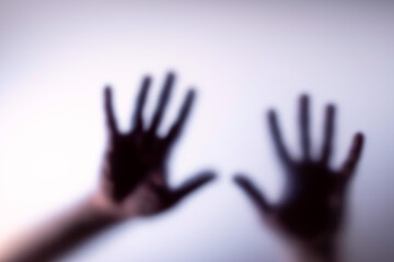 Blurred silhouette of hands and the inscription for stop .