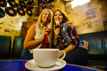Girls with alcohol glass in pub club