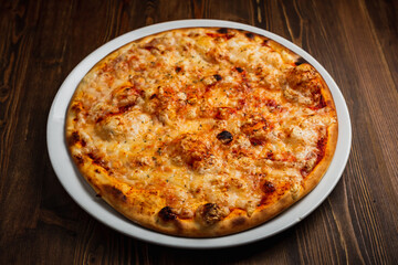 Cheese pizza with a nice crust, wooden background, low key