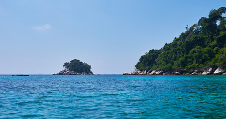 Fototapeta premium Turquoise sea, rain forest, rocks, ocean. Exploring tropical paradise island. Perfect getaway. Relaxing. Travel concept and idea. Beautiful azure ocean.