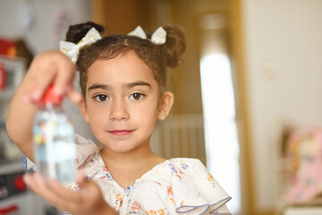Portrait of a beautiful girl showing a jar of gel painted by her.