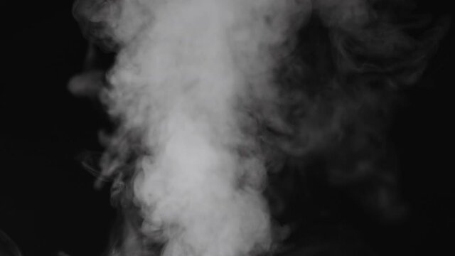 Slow motion water mist puff cloud over black background