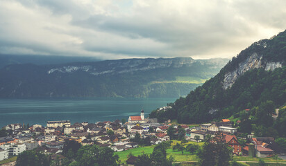 Fototapeta na wymiar View of Lake Lucerne with Gersau town and Swiss Alps in the background. Canton of Schwyz, Switzerland.