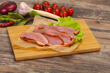 Sliced smoked duck breast served salad