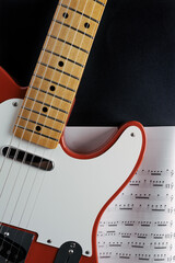 red guitar on musical scores
