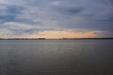 sunset above Larnaka salt lake and city, cloudy sky