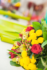 The work of the florist. Flower packaging. Creating a flower bouquet. Roses in a package. The hands of the florist. Selective focus. 