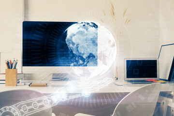 Double exposure of desktop with computer and world map hologram. International data network concept.