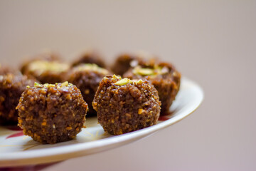 Fresh Homemade ladoo or laddu, made by bread crumbs with pistachio on it, with selective focus

