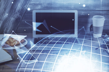Multi exposure of table with computer and world map hologram. International data network concept.