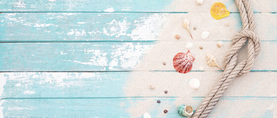 pattern sea shell and rope on a blue old wooden background with sand. Summer time holiday concept....