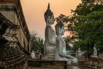 Buddha statues at sunset inside Wat Yai Chai Mongkhon, a Buddhist temple of archaeological park, Ayutthaya, Thailand