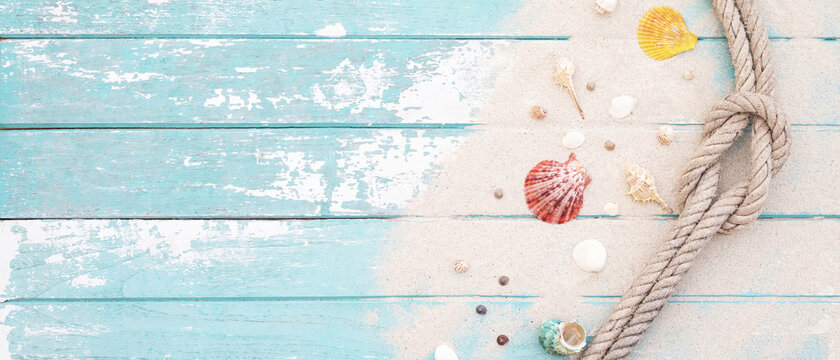 pattern sea shell and rope on a blue old wooden background with sand. Summer time holiday concept. Top view. Leave a copy space for writing descriptive text. tone colorful pastel.