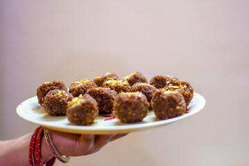 Fresh Homemade ladoo or laddu, made by bread crumbs with pistachio on it, with selective focus
